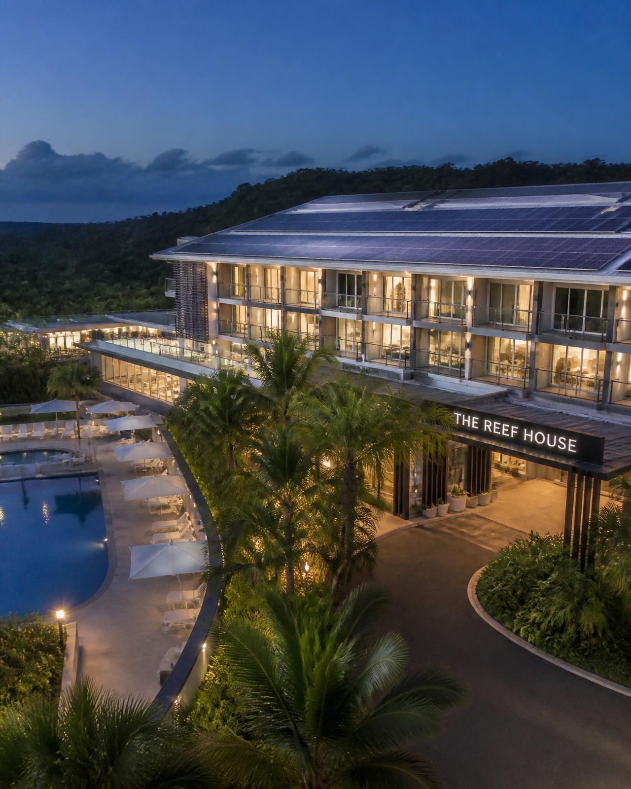 Coastal Queensland resort with solar panels on the roof at twilight